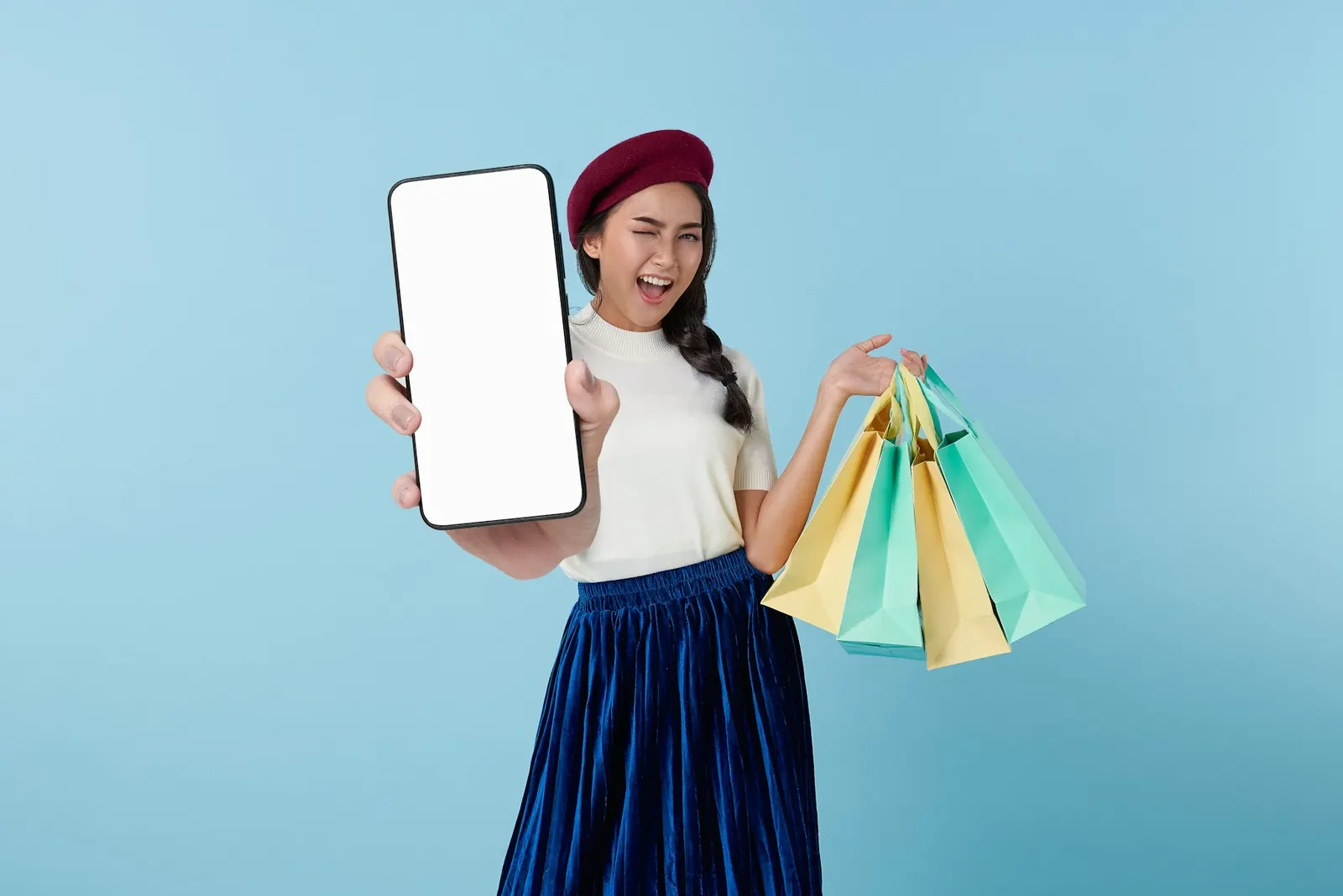 Una ragazza con le borse della spesa e il telefono in mano